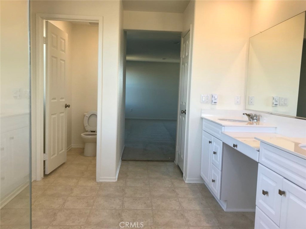 16031 Cordova Road Victorville, CA 92394 - Photo 21 of 34 a bathroom with a granite countertop sink mirror and a