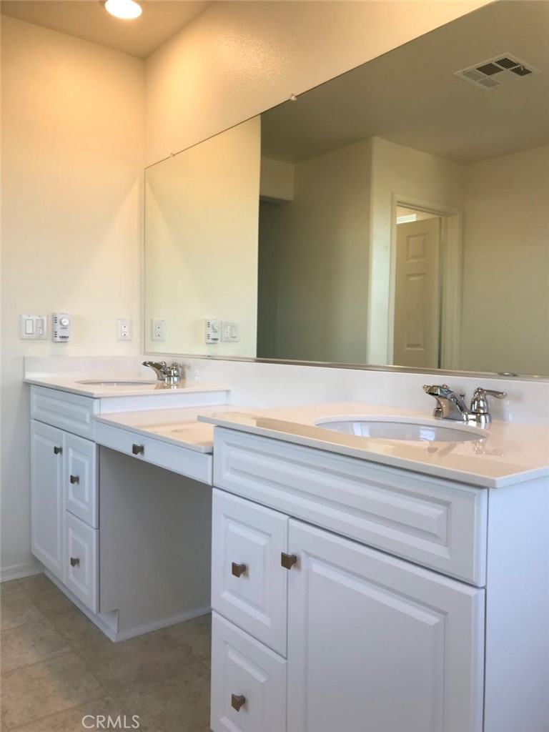 16031 Cordova Road Victorville, CA 92394 - Photo 27 of 34 a bathroom with a sink and a mirror