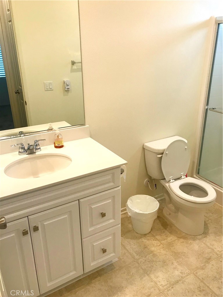 16031 Cordova Road Victorville, CA 92394 - Photo 28 of 34 a bathroom with a toilet sink and mirror