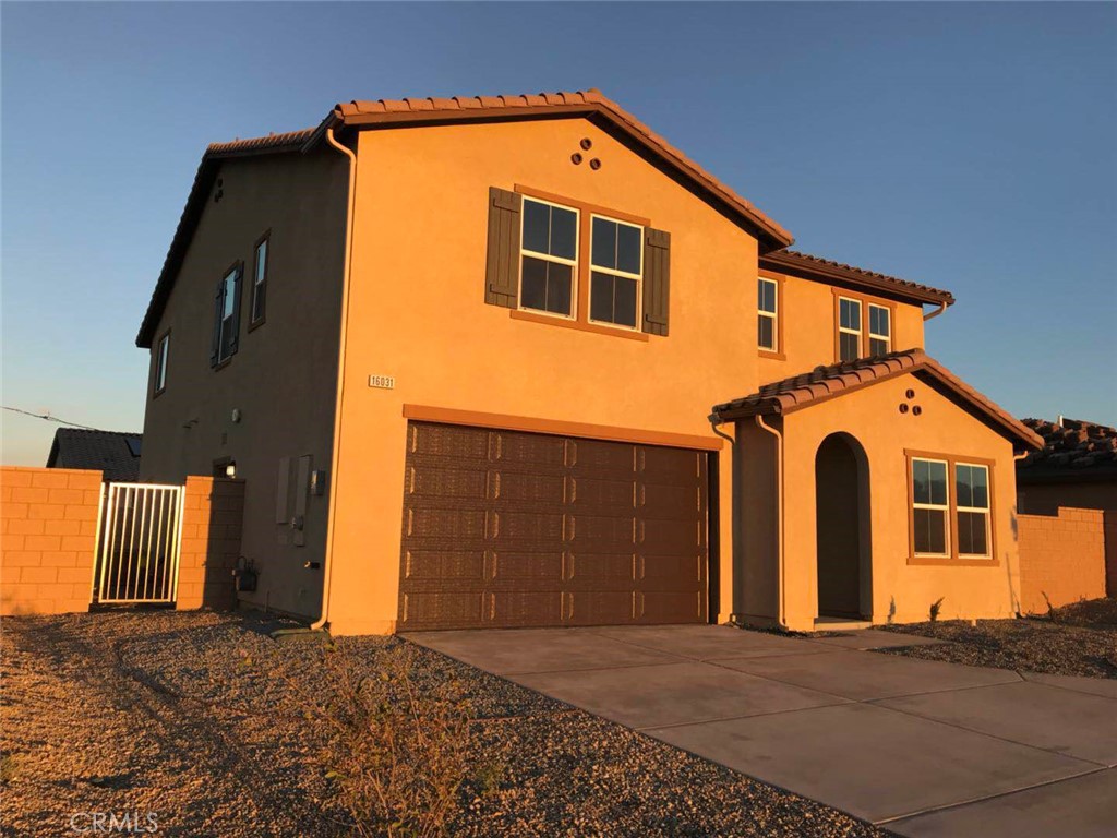 16031 Cordova Road Victorville, CA 92394 - Photo 4 of 34 a front view of a house with a garage
