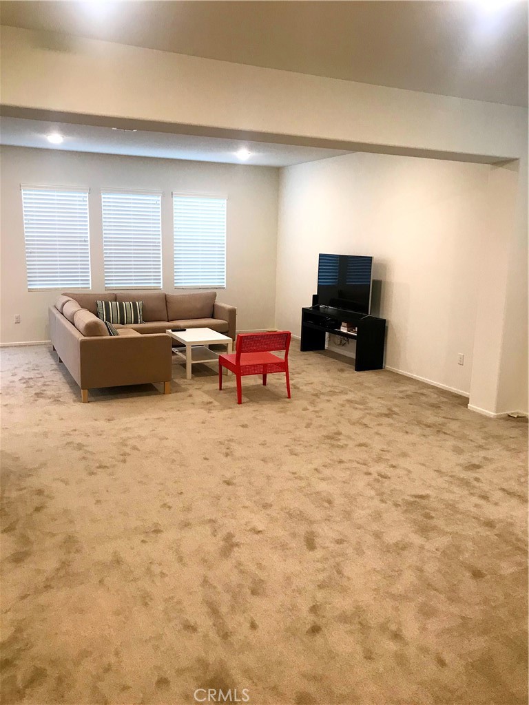16031 Cordova Road Victorville, CA 92394 - Photo 8 of 34 a living room with furniture and a flat screen tv
