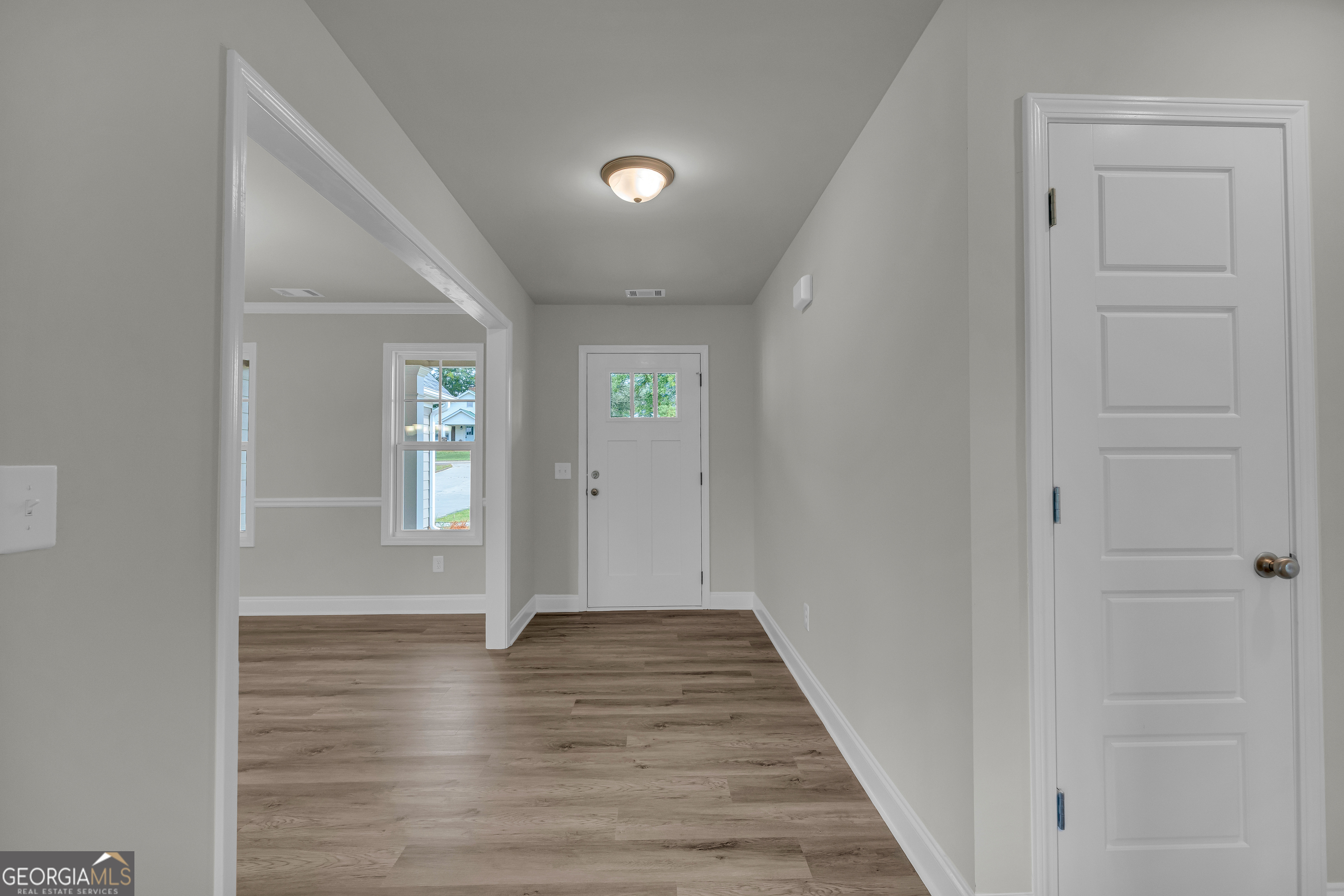 110 Sewell Road Lavonia, GA 30553 - Photo 12 of 73 a view of an empty room with wooden floor and a window