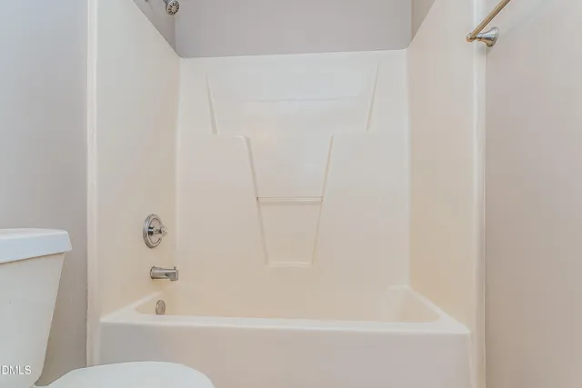 a bathroom with a bathtub and a toilet