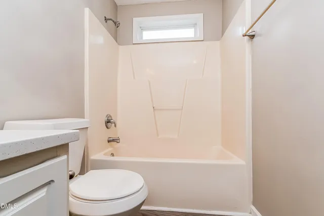 a bathroom with a toilet and a bathtub