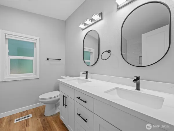 a bathroom with a toilet a sink and a mirror