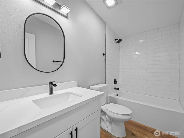 a bathroom with a sink a toilet and a mirror