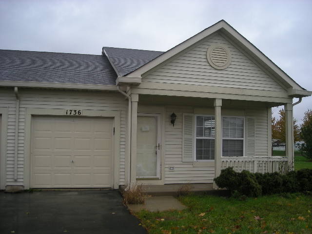 1736 Raleigh Trail Romeoville, IL 60446 - Photo 1 of 7 a front view of a house with a garden