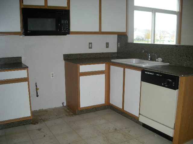 1736 Raleigh Trail Romeoville, IL 60446 - Photo 2 of 7 a kitchen with granite countertop white cabinets and black appliances