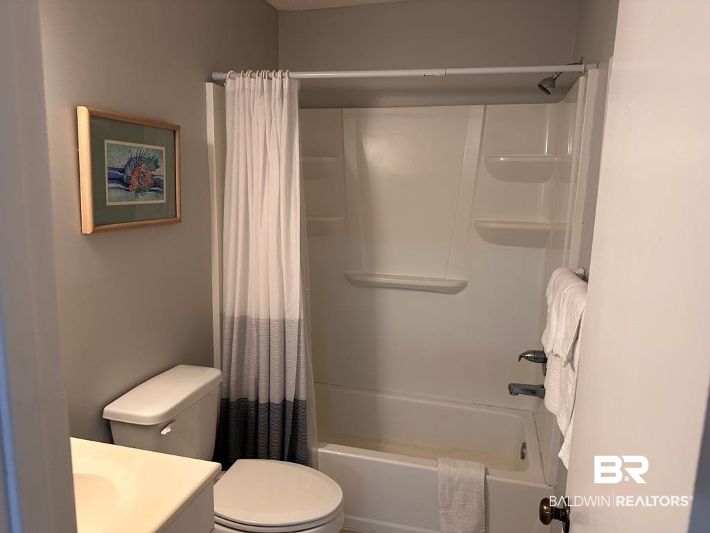 400 Plantation Road, Unit 1113 Gulf Shores, AL 36542 - Photo 10 of 26 Full bathroom featuring vanity, toilet, and shower / tub combo with curtain
