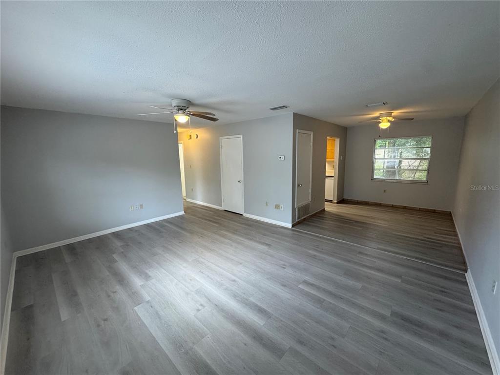 1610 High Street Leesburg, FL 34748 - Photo 3 of 11 an empty room with wooden floor and windows
