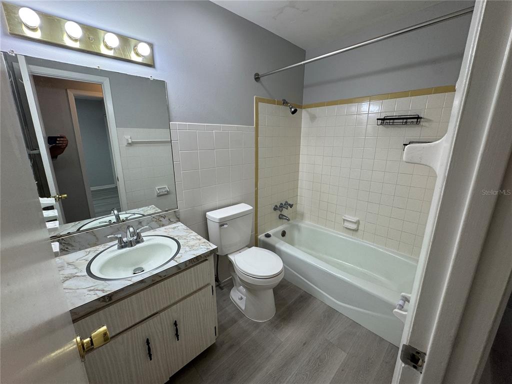 1610 High Street Leesburg, FL 34748 - Photo 10 of 11 a bathroom with a sink a toilet and shower