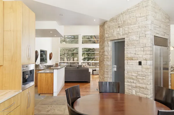 a bedroom with a bed a flat screen tv and a fireplace