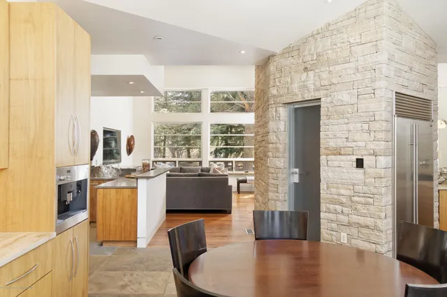 a bedroom with a bed a flat screen tv and a fireplace