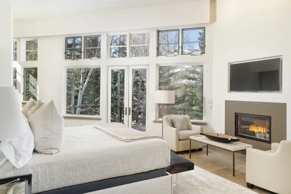 a bedroom with a bed and a flat screen tv