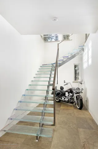 a bedroom with a bed and large window