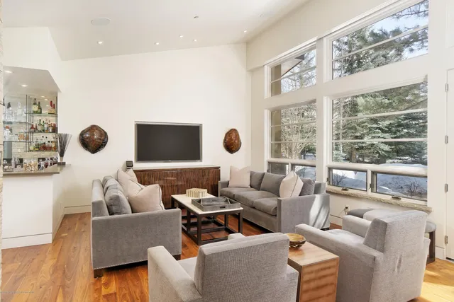 a living room with furniture and a large window