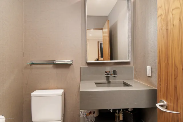 a living room with furniture and large windows