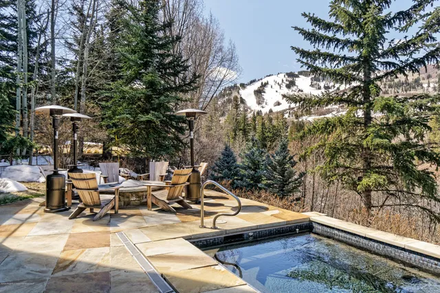 a view of a patio with dining table and chairs with wooden floor and fence