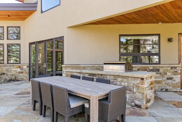 a view of a house with backyard and sitting area