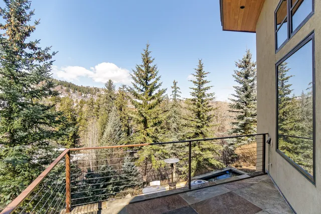 a front view of a house with yard and trees