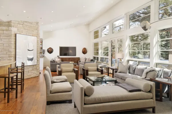 a living room with furniture and large windows