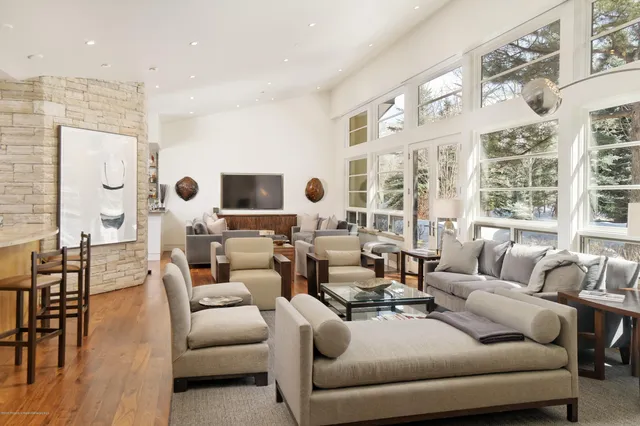 a living room with furniture and large windows