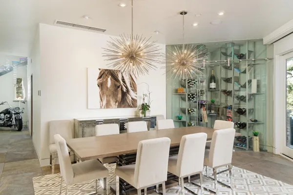 a dining room with furniture and a floor to ceiling window