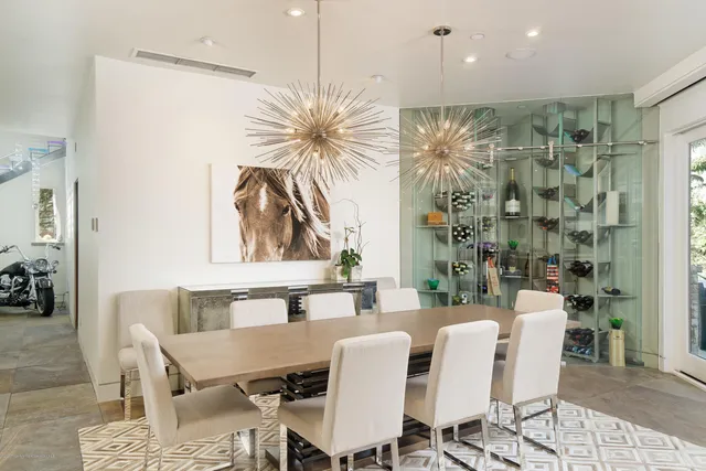 a dining room with furniture and a floor to ceiling window