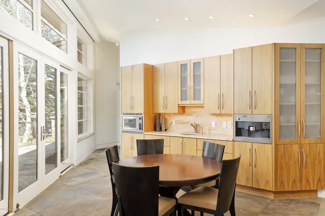 a kitchen with a sink and a mirror