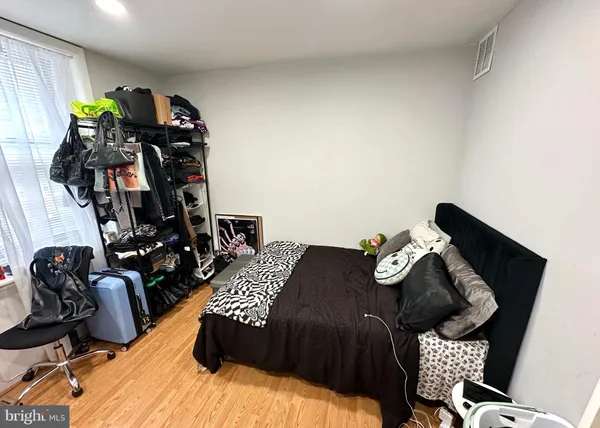 a bedroom with bed and a closet