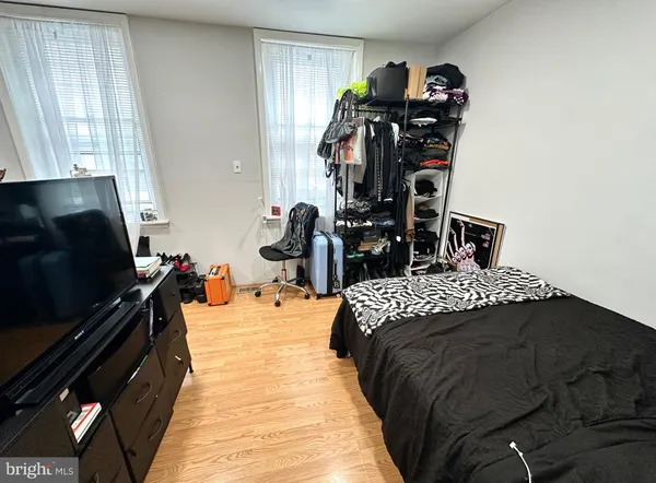 a bedroom with bed and a flat tv screen