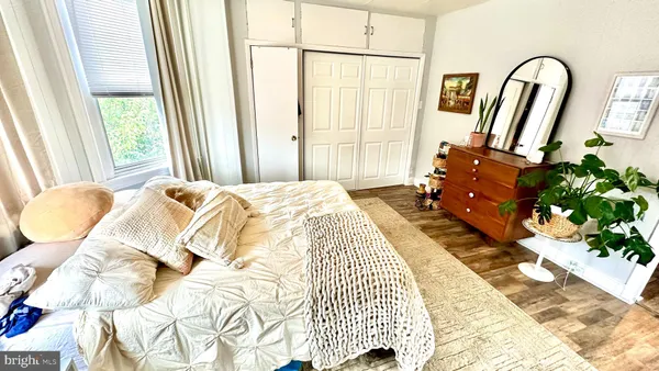 a bedroom with a bed mirror and a window