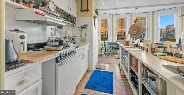 a kitchen with a sink stove and cabinets