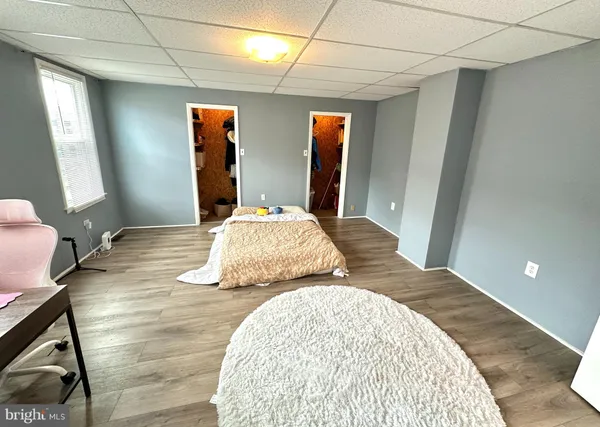 a bedroom with a bed and a mirror