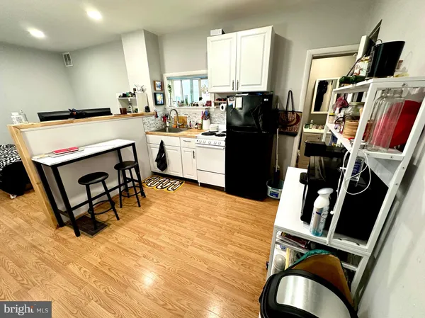 a room with furniture a flat screen tv and a window