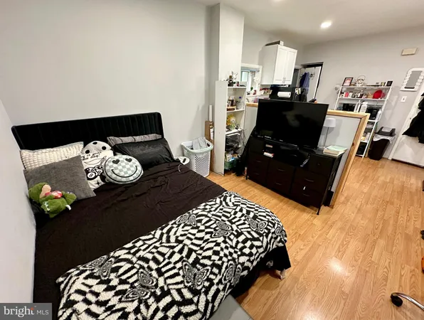 a bed room with a bed and a television