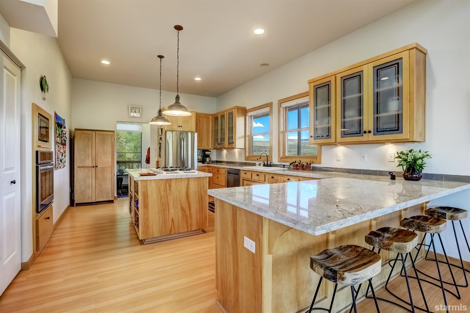 604 River Ranch Road Woodfords, CA 96120 - Photo 1 of 25 a kitchen with stainless steel appliances granite countertop a kitchen island a stove and a sink