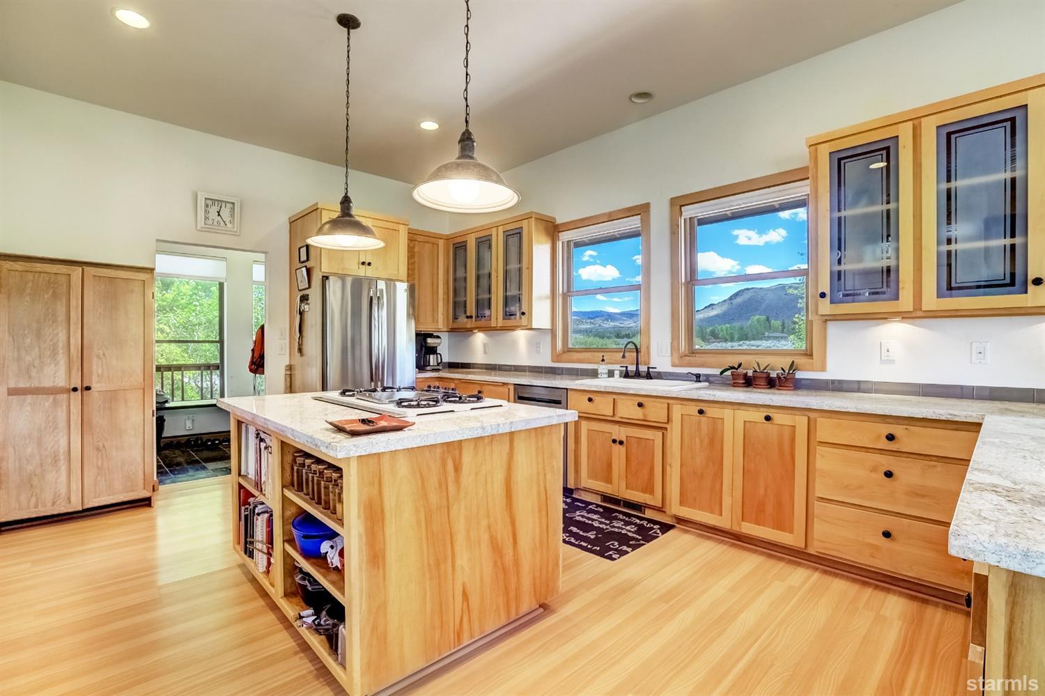 604 River Ranch Road Woodfords, CA 96120 - Photo 5 of 25 a kitchen with stainless steel appliances granite countertop a stove a sink dishwasher and a refrigerator with wooden floor