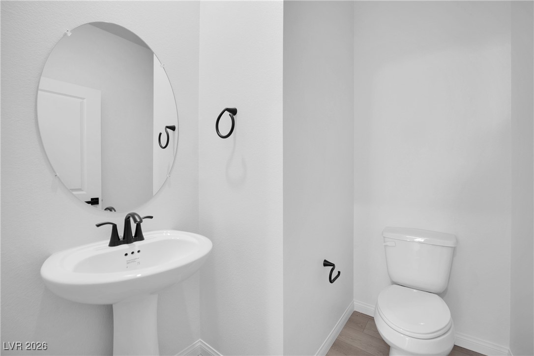9136 Rivington Avenue Las Vegas, NV 89148 - Photo 15 of 43 Bathroom featuring toilet and wood finished floors