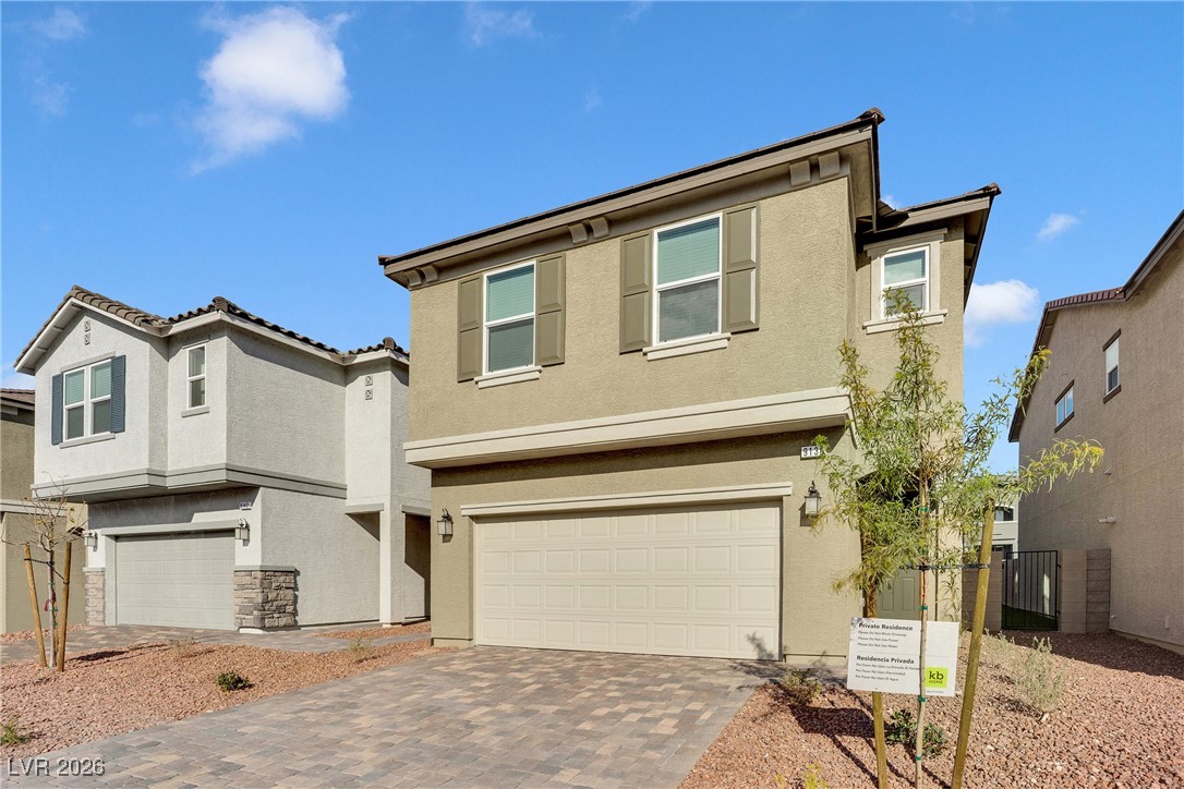 9136 Rivington Avenue Las Vegas, NV 89148 - Photo 2 of 43 View of front of property with stucco siding, decorative driveway, and an attached garage