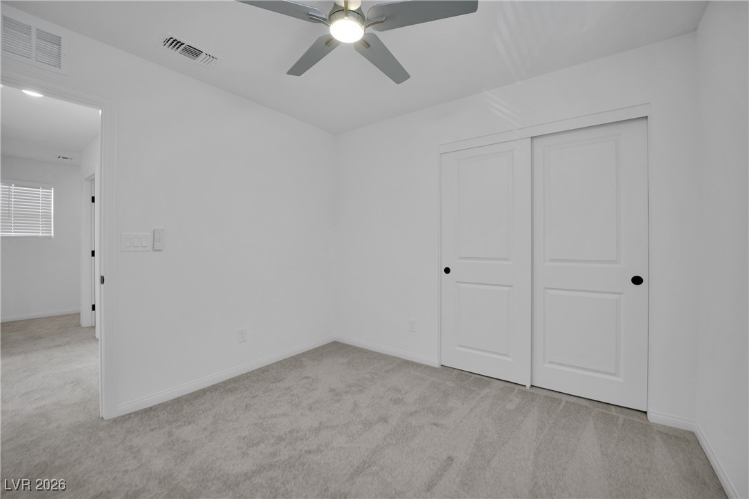 9136 Rivington Avenue Las Vegas, NV 89148 - Photo 19 of 43 Unfurnished bedroom with light colored carpet, a closet, and ceiling fan