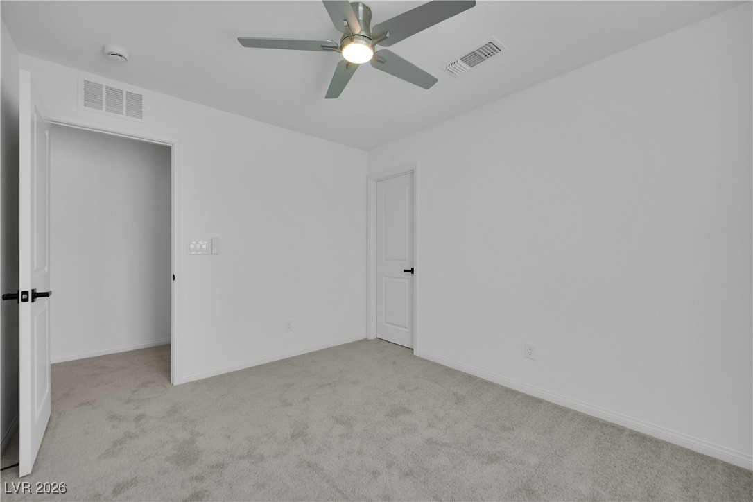 9136 Rivington Avenue Las Vegas, NV 89148 - Photo 22 of 43 Unfurnished bedroom with light colored carpet and ceiling fan