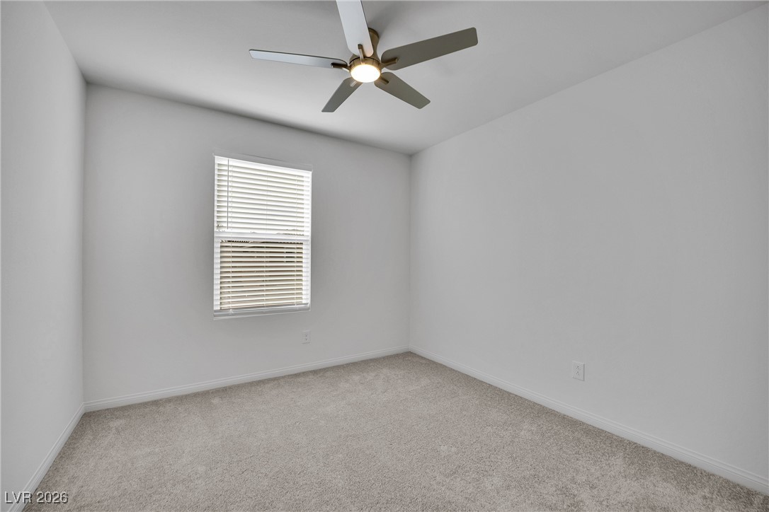 9136 Rivington Avenue Las Vegas, NV 89148 - Photo 23 of 43 Spare room featuring light carpet and a ceiling fan