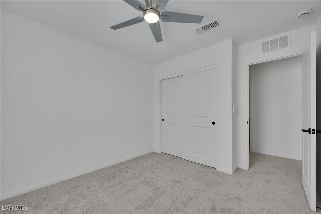 9136 Rivington Avenue Las Vegas, NV 89148 - Photo 24 of 43 Unfurnished bedroom with light carpet, a closet, and ceiling fan