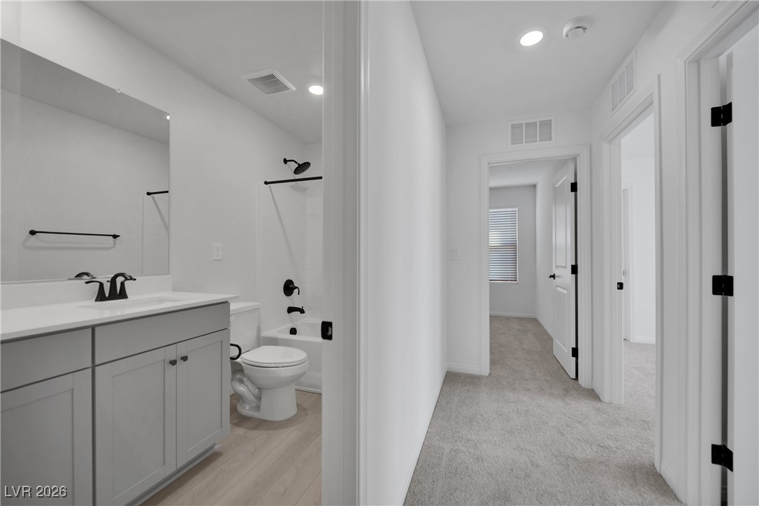 9136 Rivington Avenue Las Vegas, NV 89148 - Photo 25 of 43 Bathroom featuring vanity, shower / bathtub combination, light colored carpet, and recessed lighting