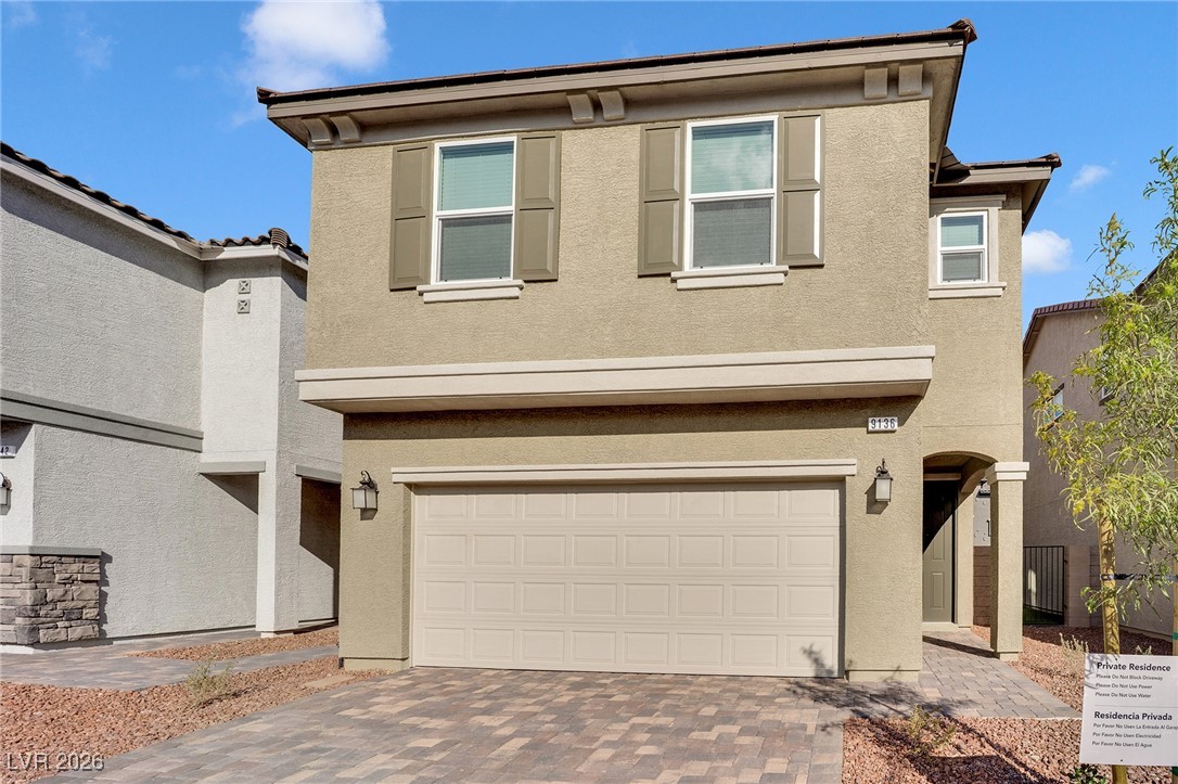 9136 Rivington Avenue Las Vegas, NV 89148 - Photo 3 of 43 View of front of house with stucco siding and decorative driveway