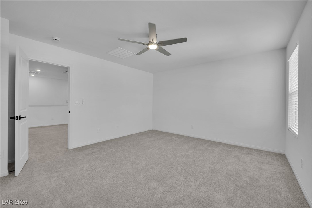 9136 Rivington Avenue Las Vegas, NV 89148 - Photo 31 of 43 Empty room with light colored carpet and a ceiling fan