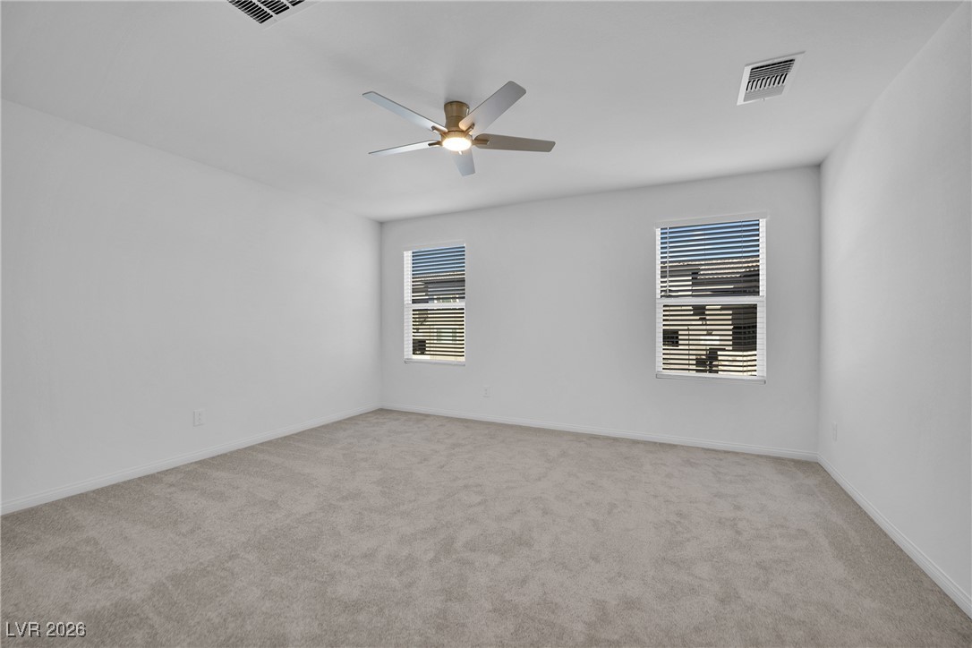 9136 Rivington Avenue Las Vegas, NV 89148 - Photo 32 of 43 Spare room with light carpet and a ceiling fan