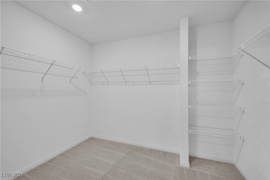 9136 Rivington Avenue Las Vegas, NV 89148 - Photo 35 of 43 Walk in closet featuring light carpet