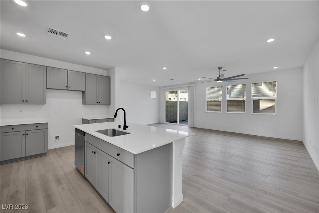 9136 Rivington Avenue Las Vegas, NV 89148 - Photo 42 of 43 Kitchen featuring gray cabinets, recessed lighting, open floor plan, and light stone countertops